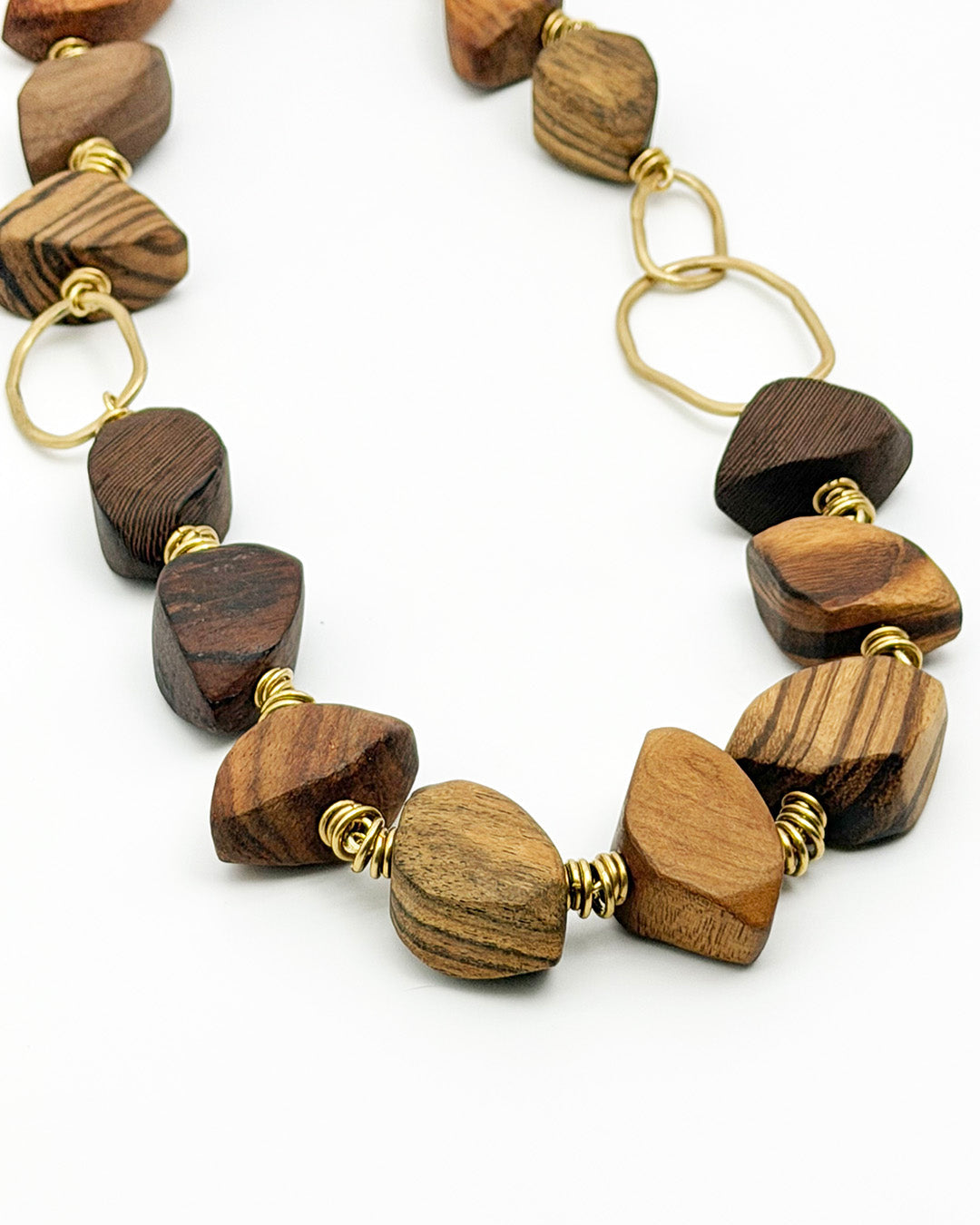 Necklace with wooden beads and gold accents on a white background