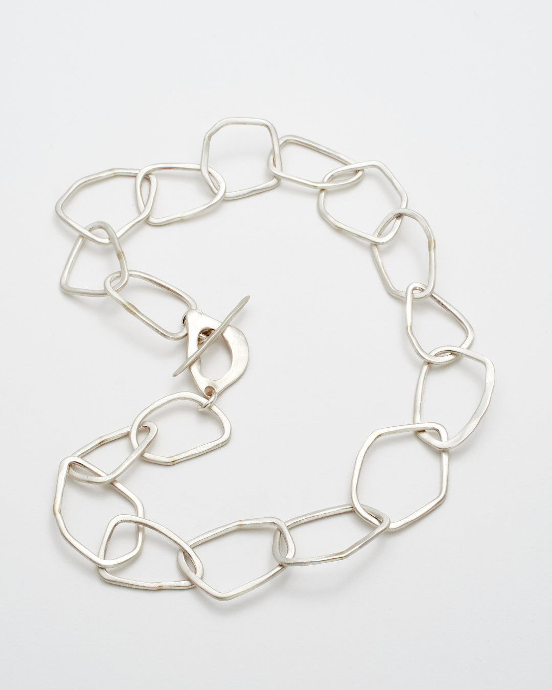 Silver link necklace on a light gray background