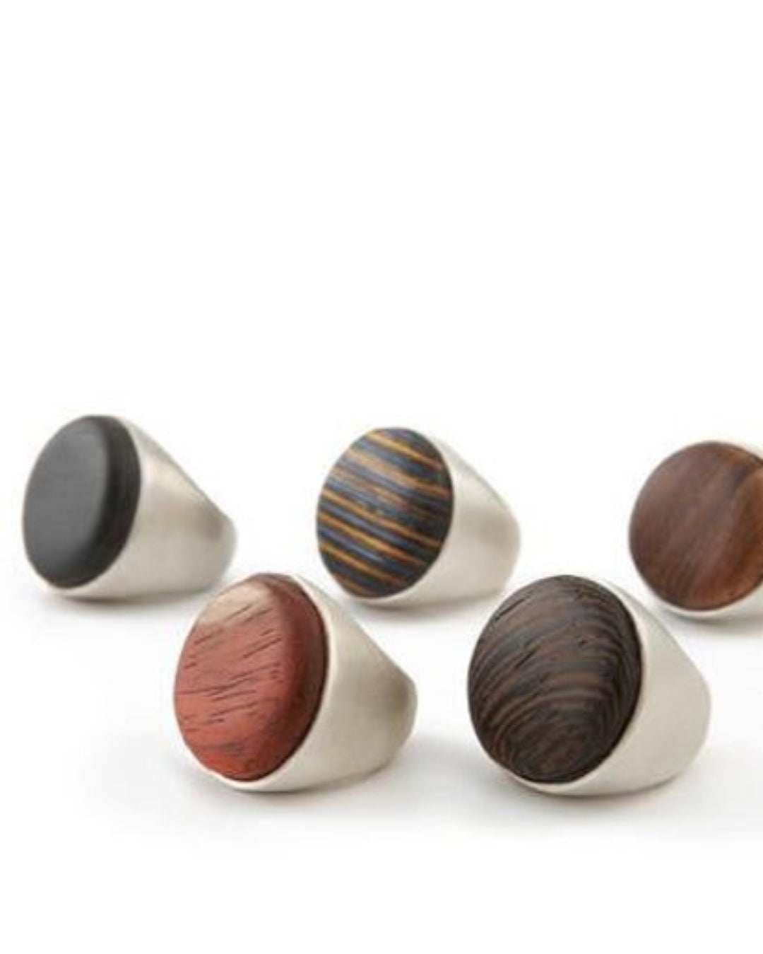 Five silver rings with wooden details 
on a white background