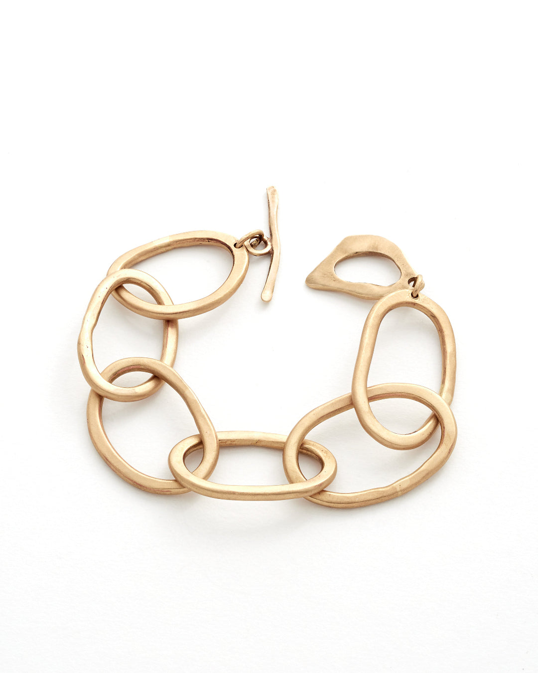 Gold chain-link bracelt on a white background