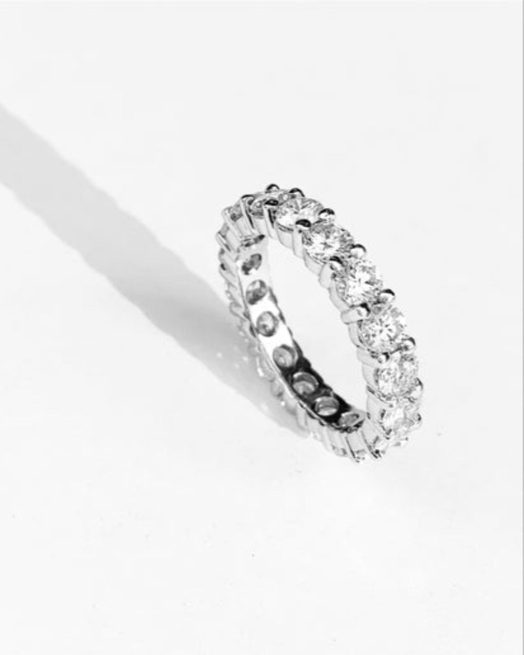 Silver diamond band on a white background