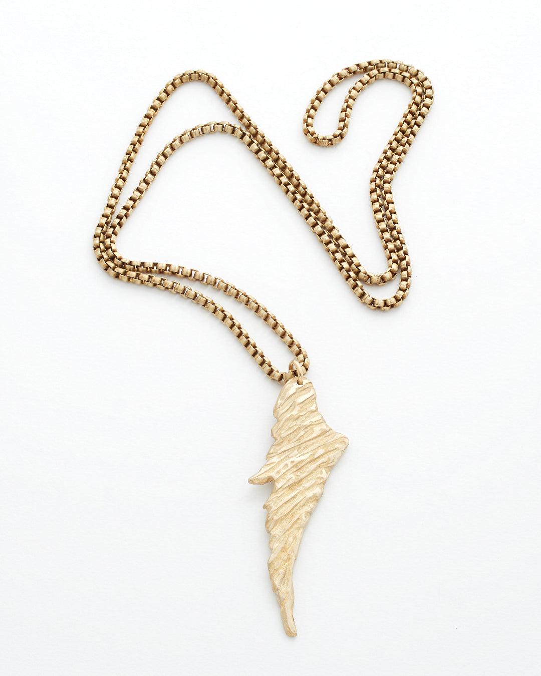 Gold necklace with a wing-shaped pendant on a white background