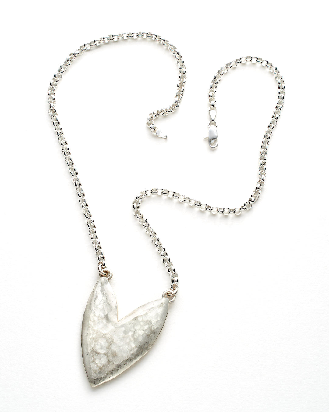 Silver necklace with a heart-shaped pendant on a white background