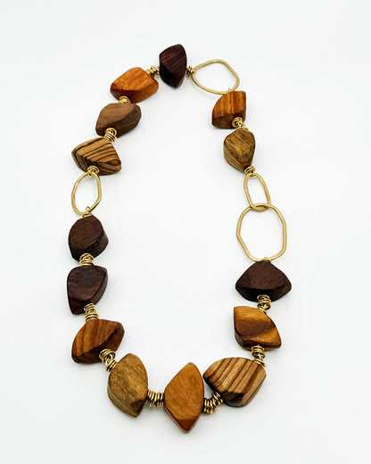 Necklace with wooden beads and gold accents on a white background
