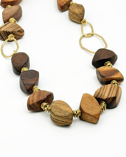 Necklace with wooden beads and gold accents on a white background