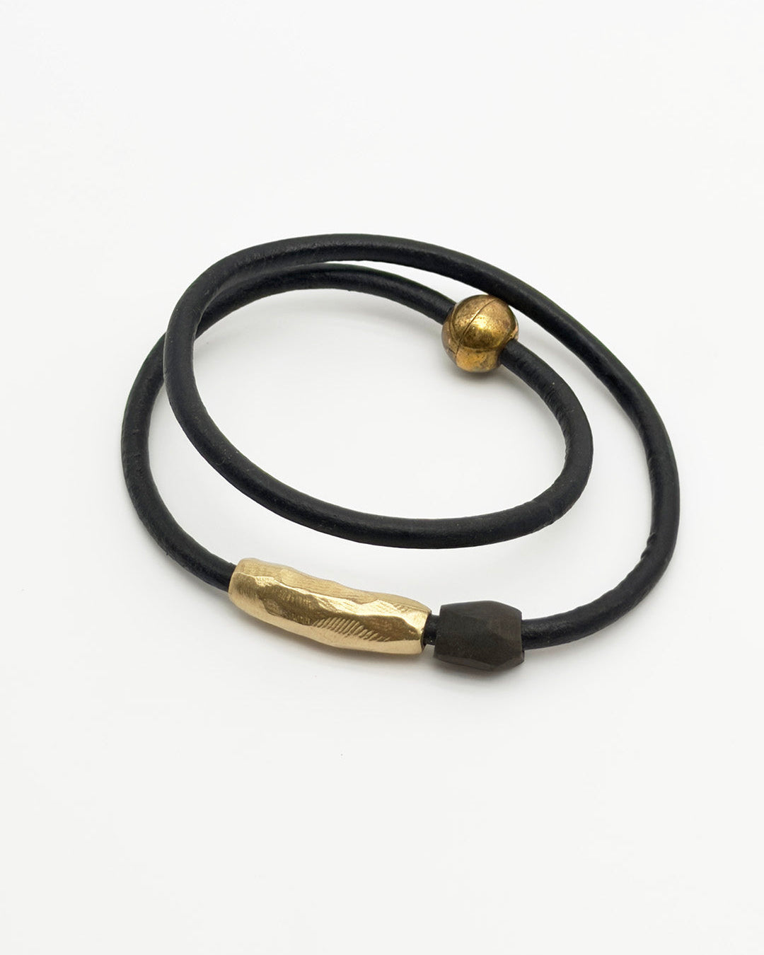 Black leather cord with gold metal clasps on a white background