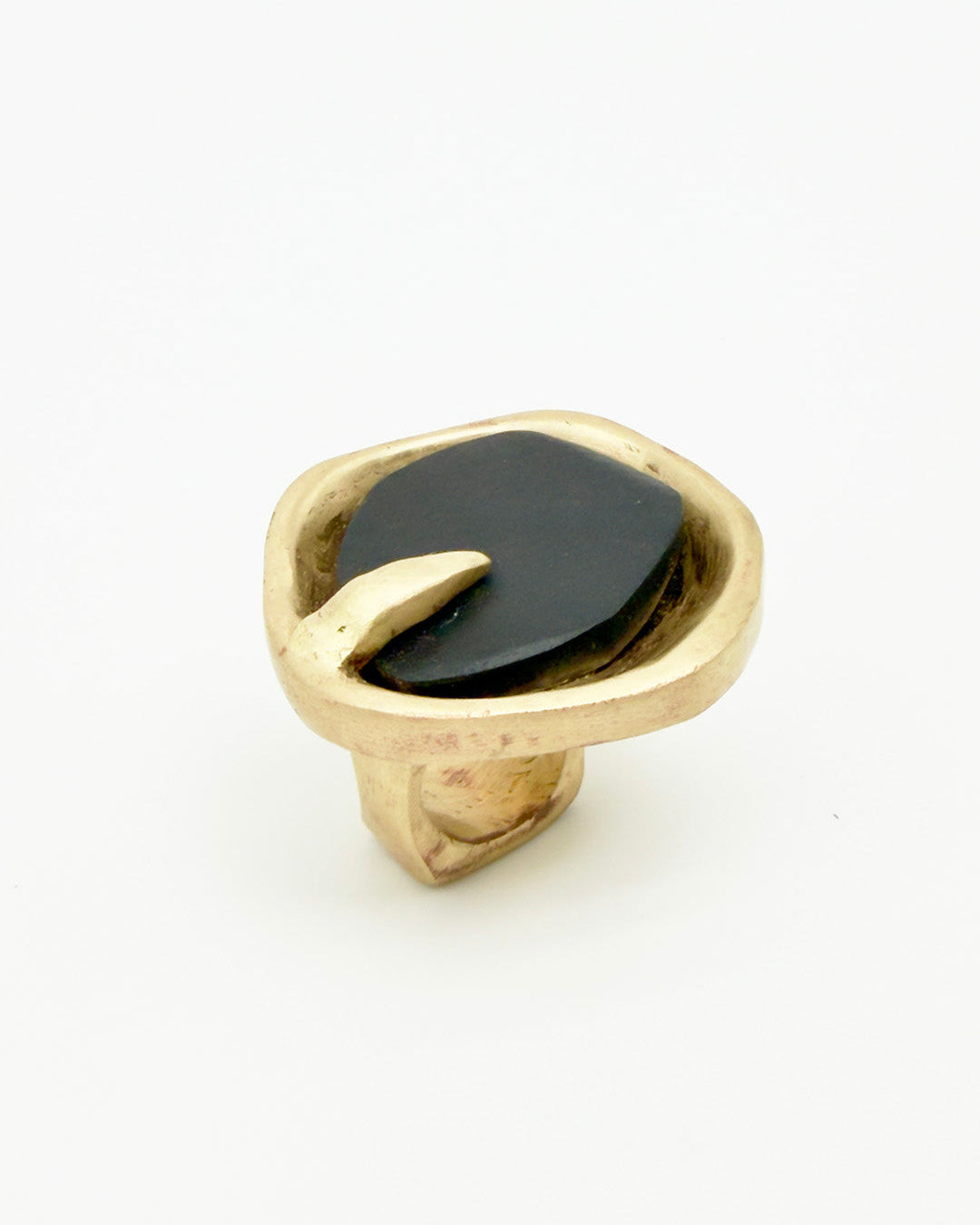 Gold ring with a black stone on a white background