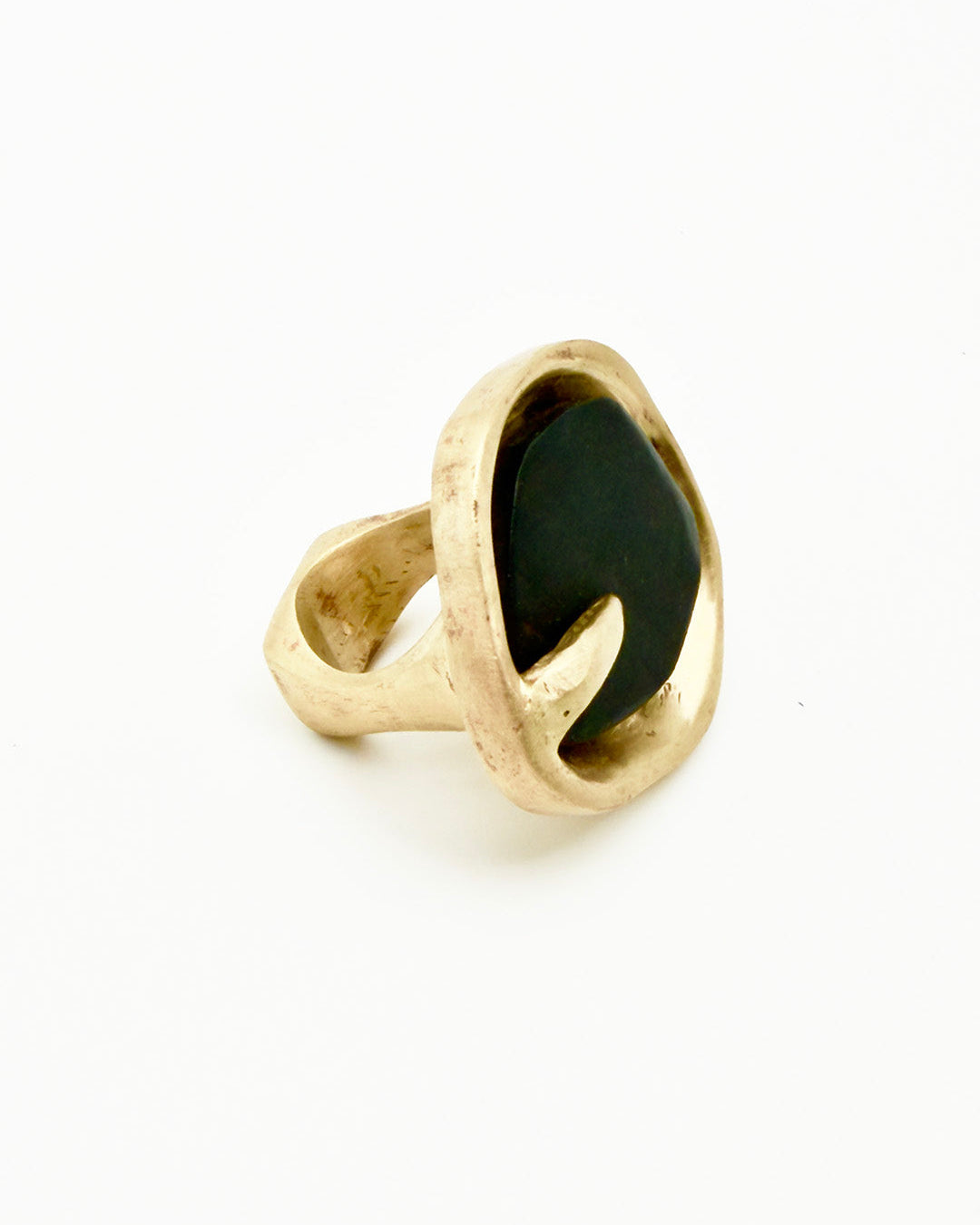 Gold ring with a black stone on a white background