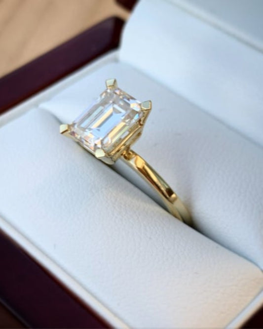 Gold ring with a large diamond in an open jewelry box