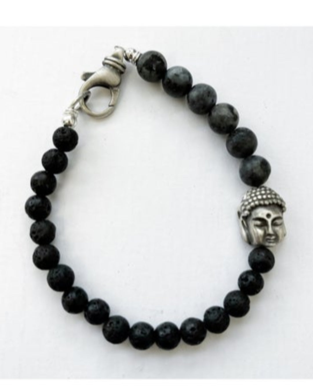 Black beaded bracelet with a silver Buddha head charm on a white background