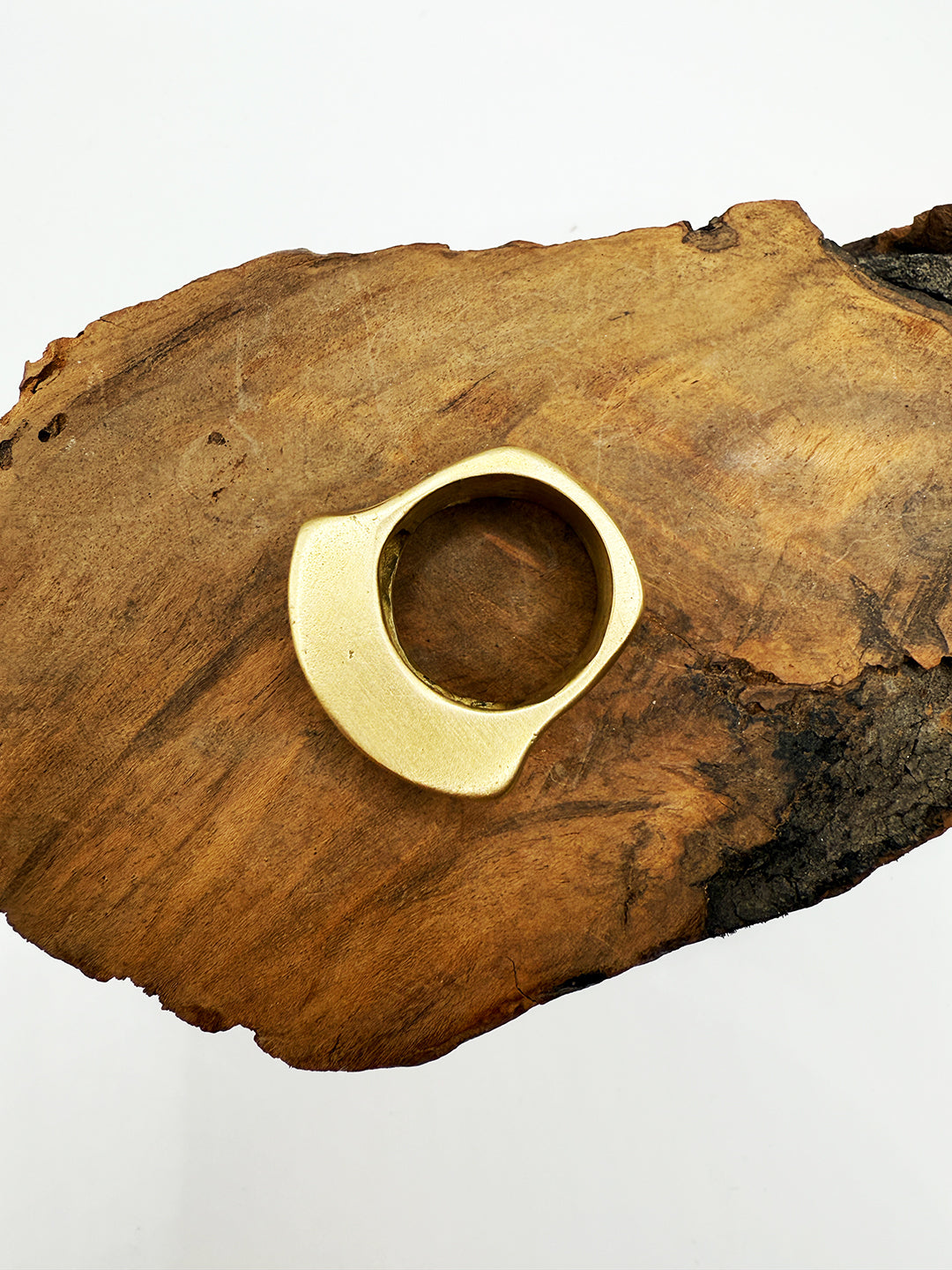 Gold ring on a wooden surface