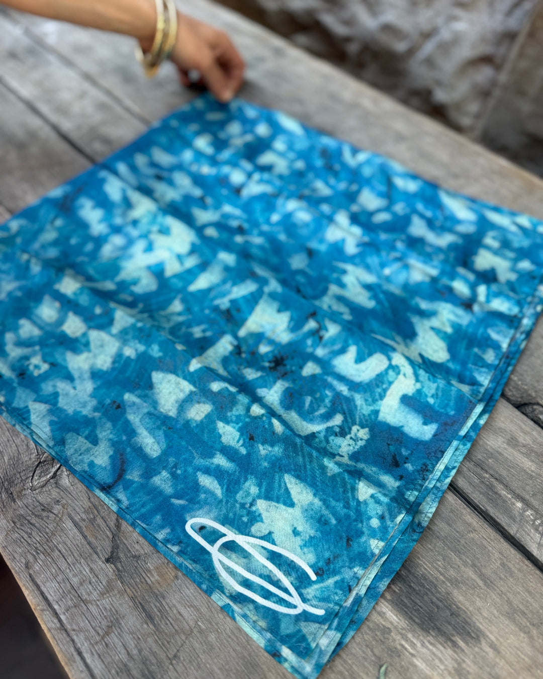 Blue patterned fabric on a wooden surface