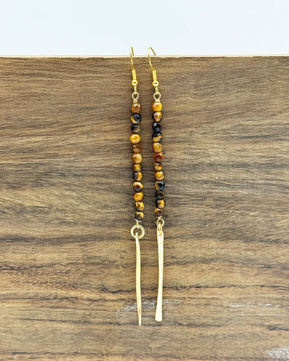 Beaded earrings on a wooden surface
