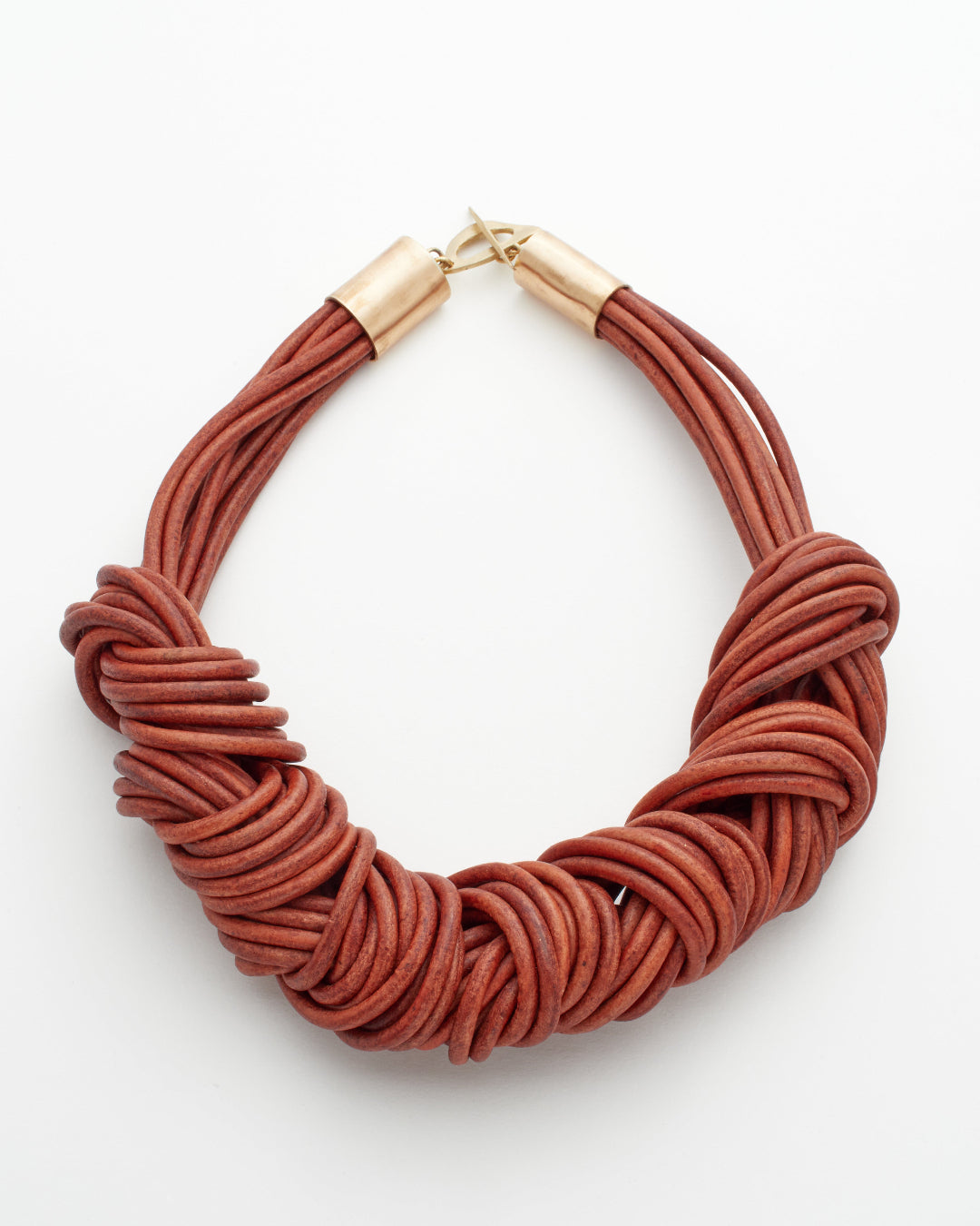 Brown multistrand leather knotted necklace with gold clasp on a white background
