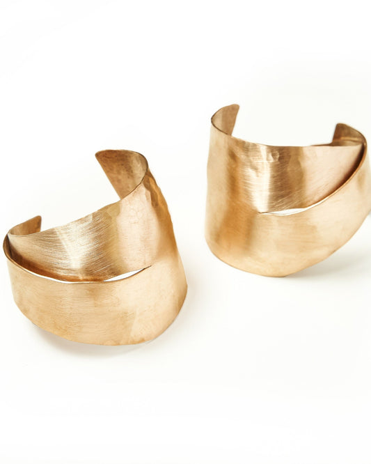 Two bronze cuffs on a white background