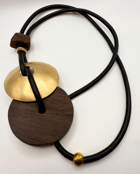 Necklace with wooden and brass pendants on a white background