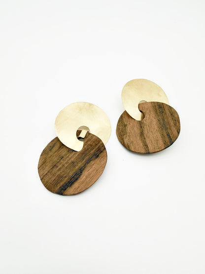 Wooden and gold earrings on a white background
