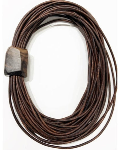 Brown multistrand leather necklace with a wooden detail on a white background