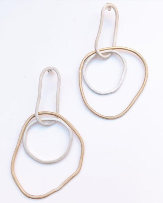 Pair of gold and silver hoop earrings on a white background