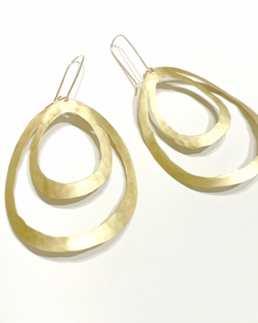 Gold teardrop hoop earrings on a white background
