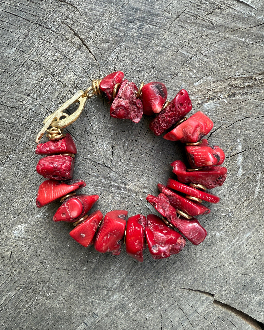 Red coral bracelet on a wooden surface