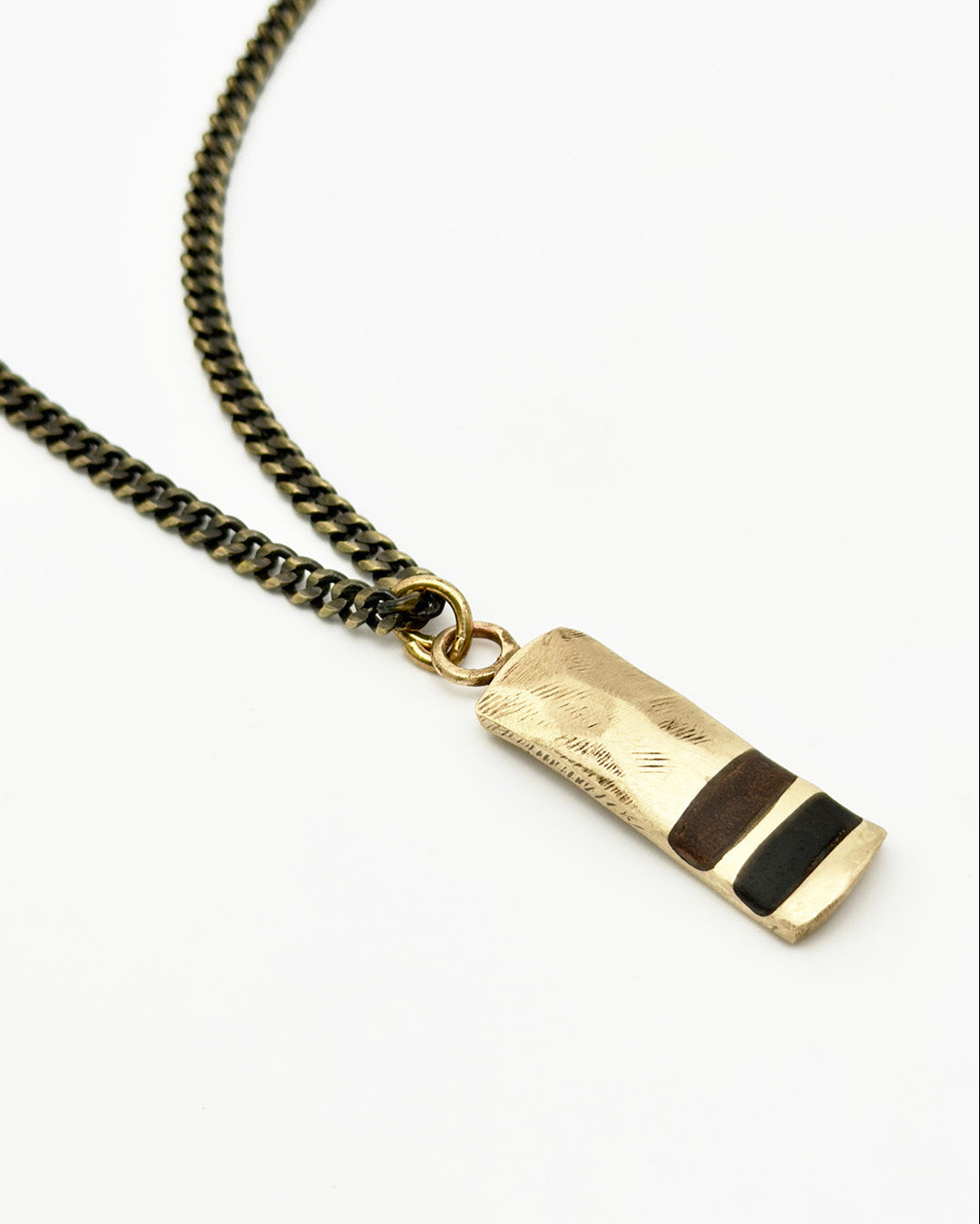 Gold necklace with a rectangular pendant on a white background