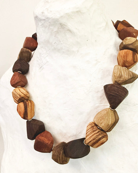 Necklace with wooden beads on a white fabric background