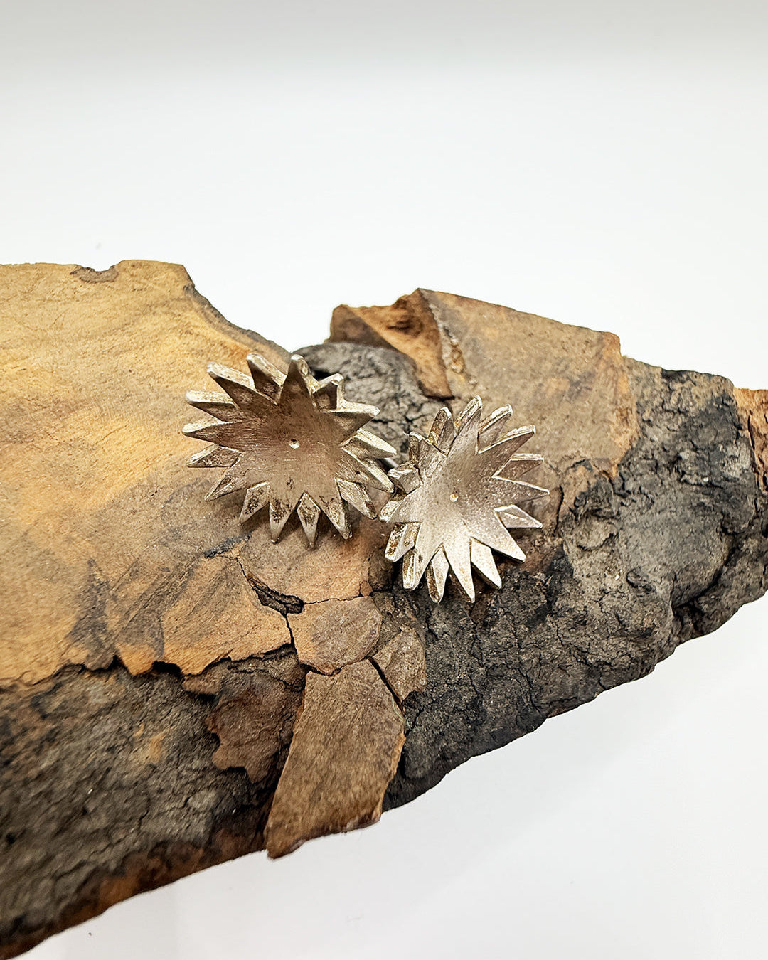 Decorative metal sunflower pieces on a textured stone surface