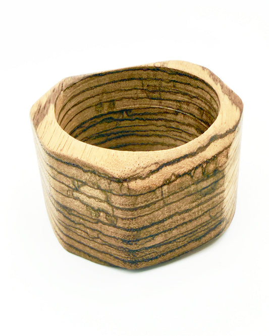 Wooden bowl with a striped pattern on a white background
