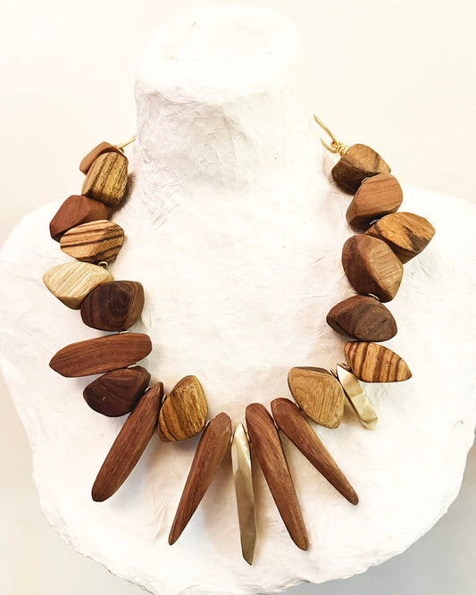 Wooden necklace with natural brown and beige stones on a white background