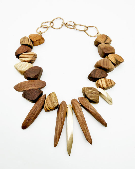 Wooden necklace with gold accents on a white background