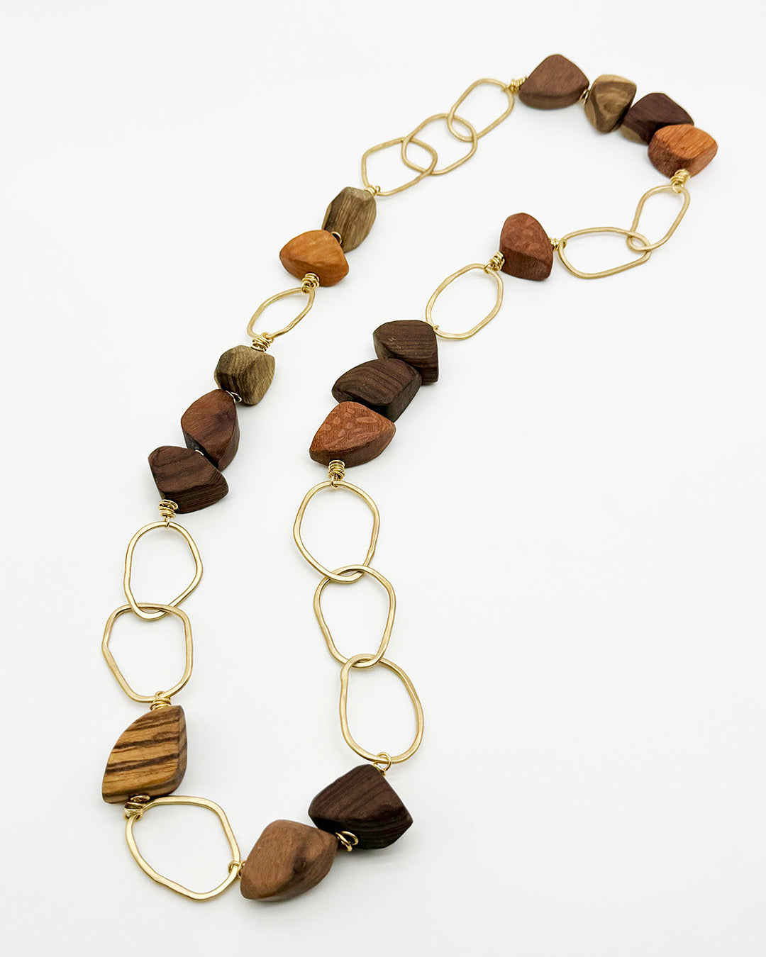 Necklace with wooden beads and gold chain on a white background
