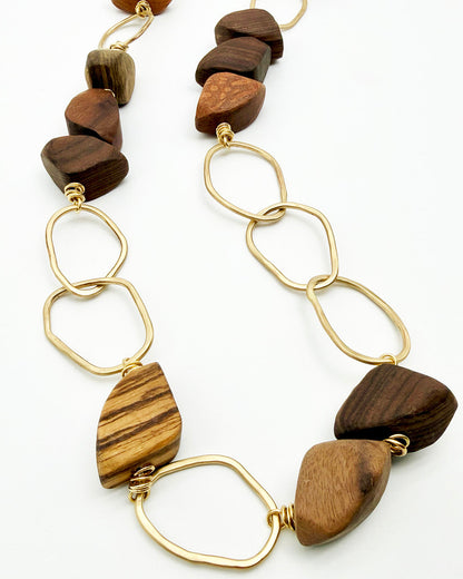 Necklace with wooden beads and gold links on a white background