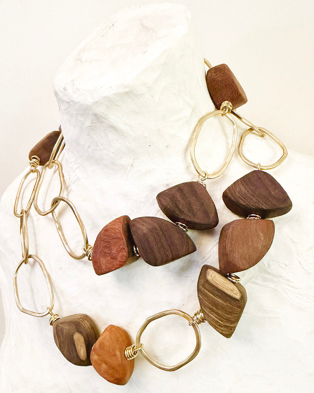 Wooden bead necklace and earrings on a white background