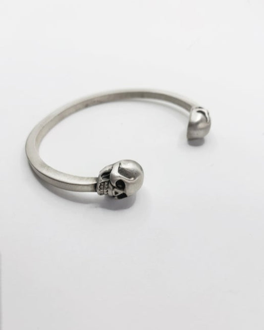 Silver skull-themed bangle on a white background