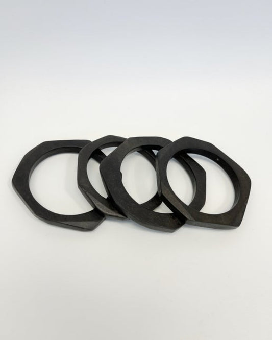 Four ebony bangles on a neutral background