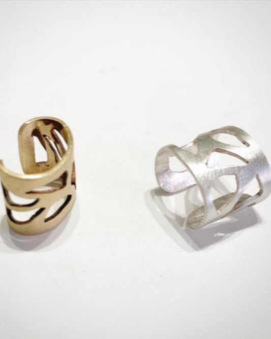 Bronze and silver openwork rings on a white background