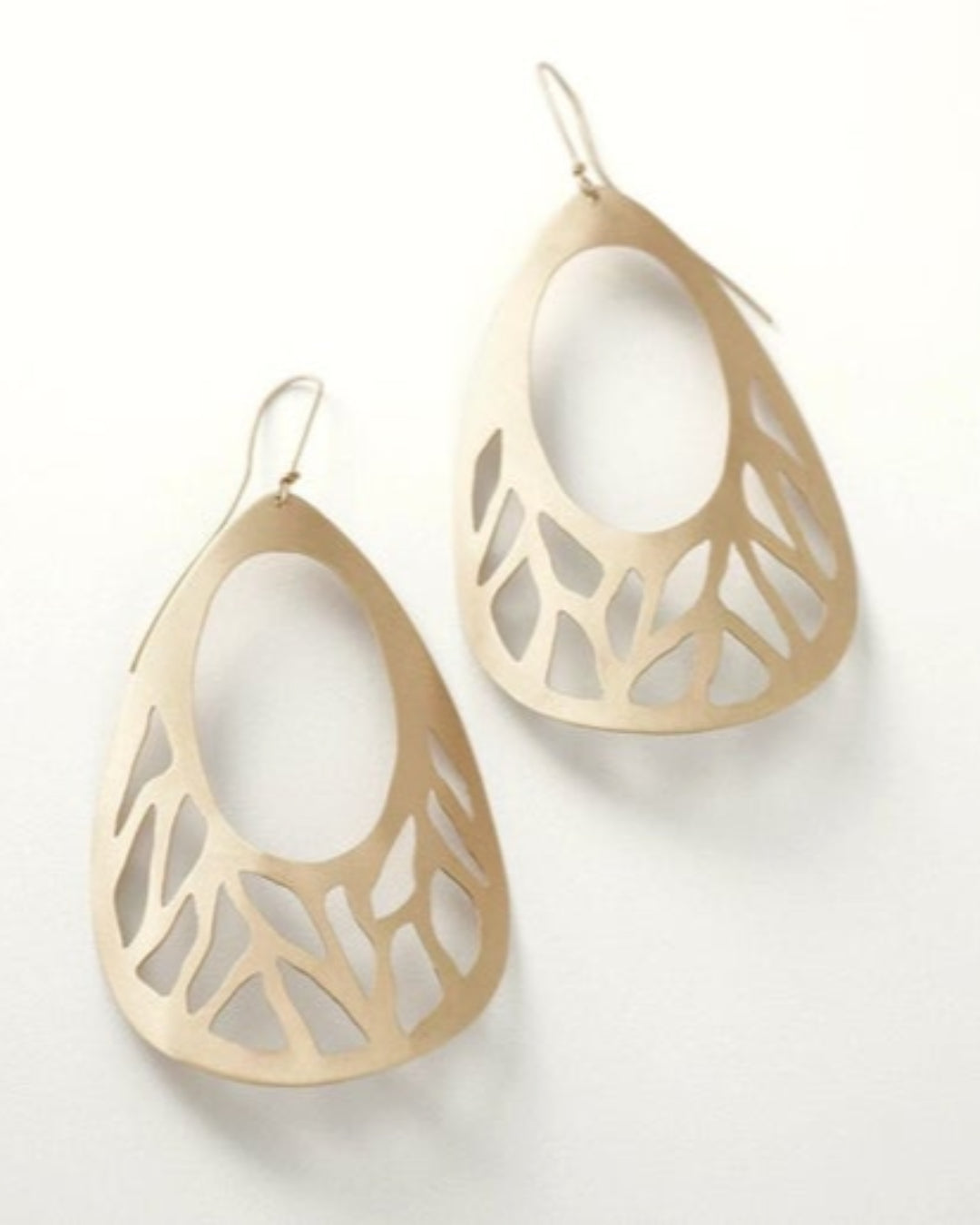Gold earrings with intricate designs on a white background
