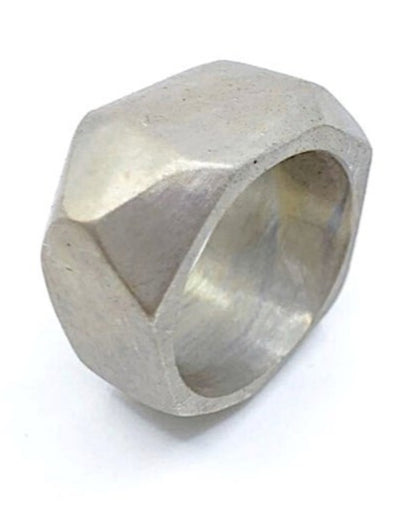 Silver ring with geometric design on a white background