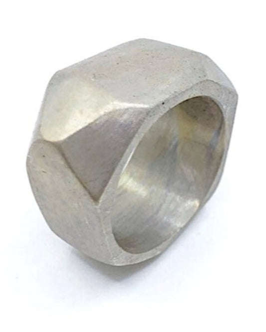 Silver ring with geometric design on a white background