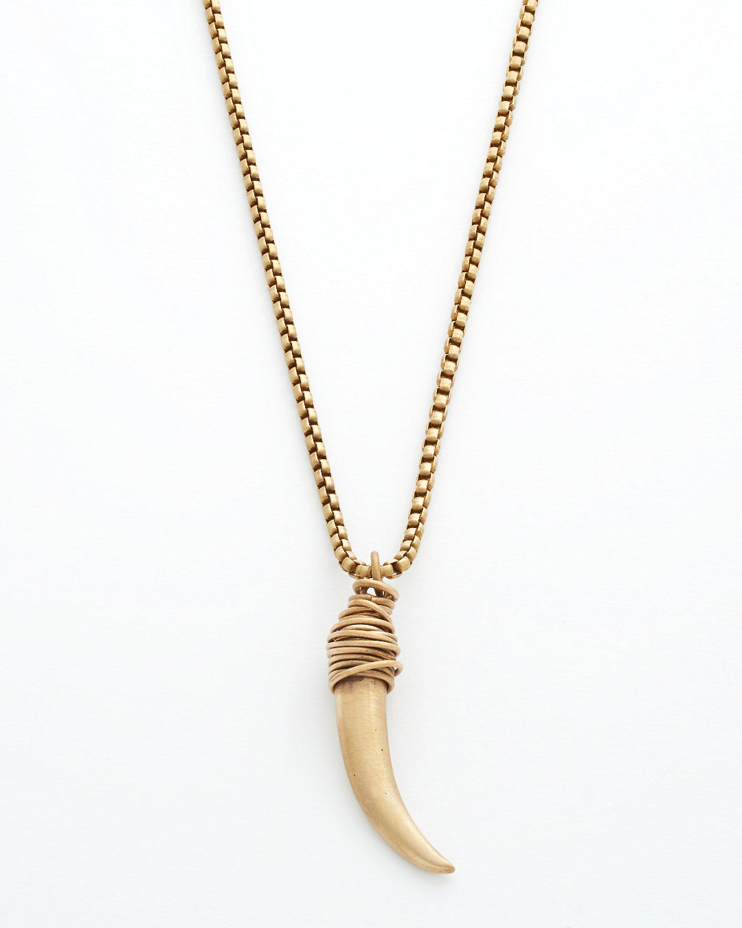 Gold necklace with a horn shaped pendant on a white background