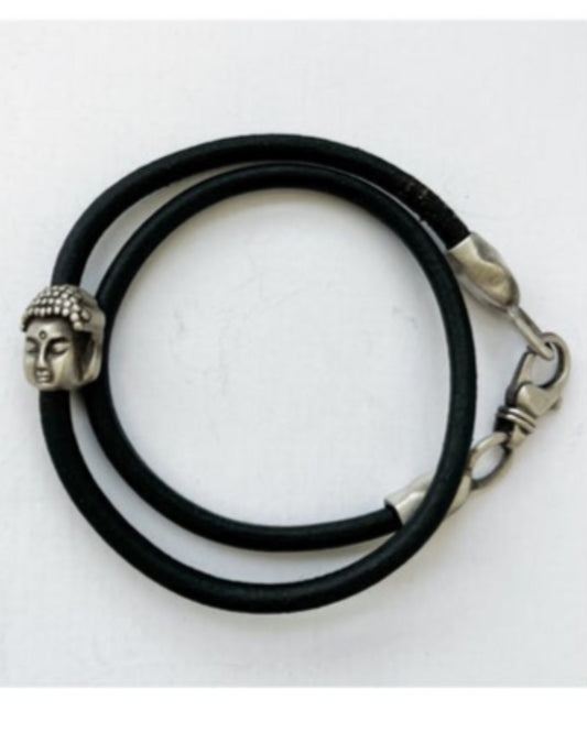 Black leather bracelet with silver Buddha head charm on a white background