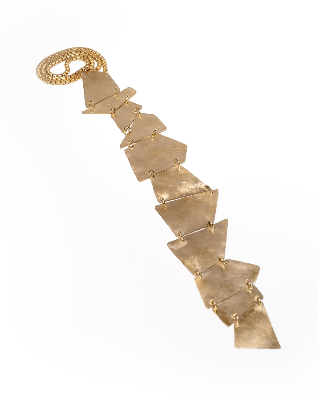 Gold necklace with geometric pendants on a white background