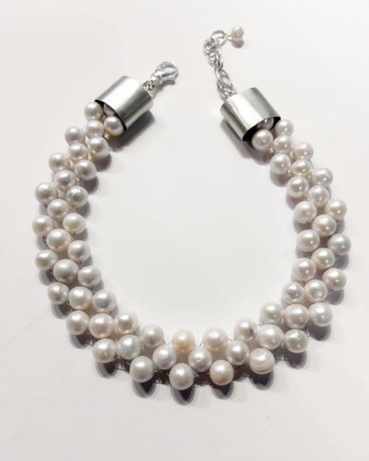 Pearl necklace with silver clasp on a white background