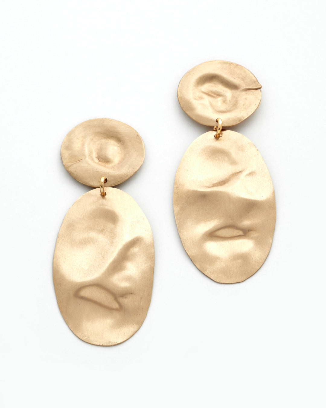Textured bronze earrings on a white background