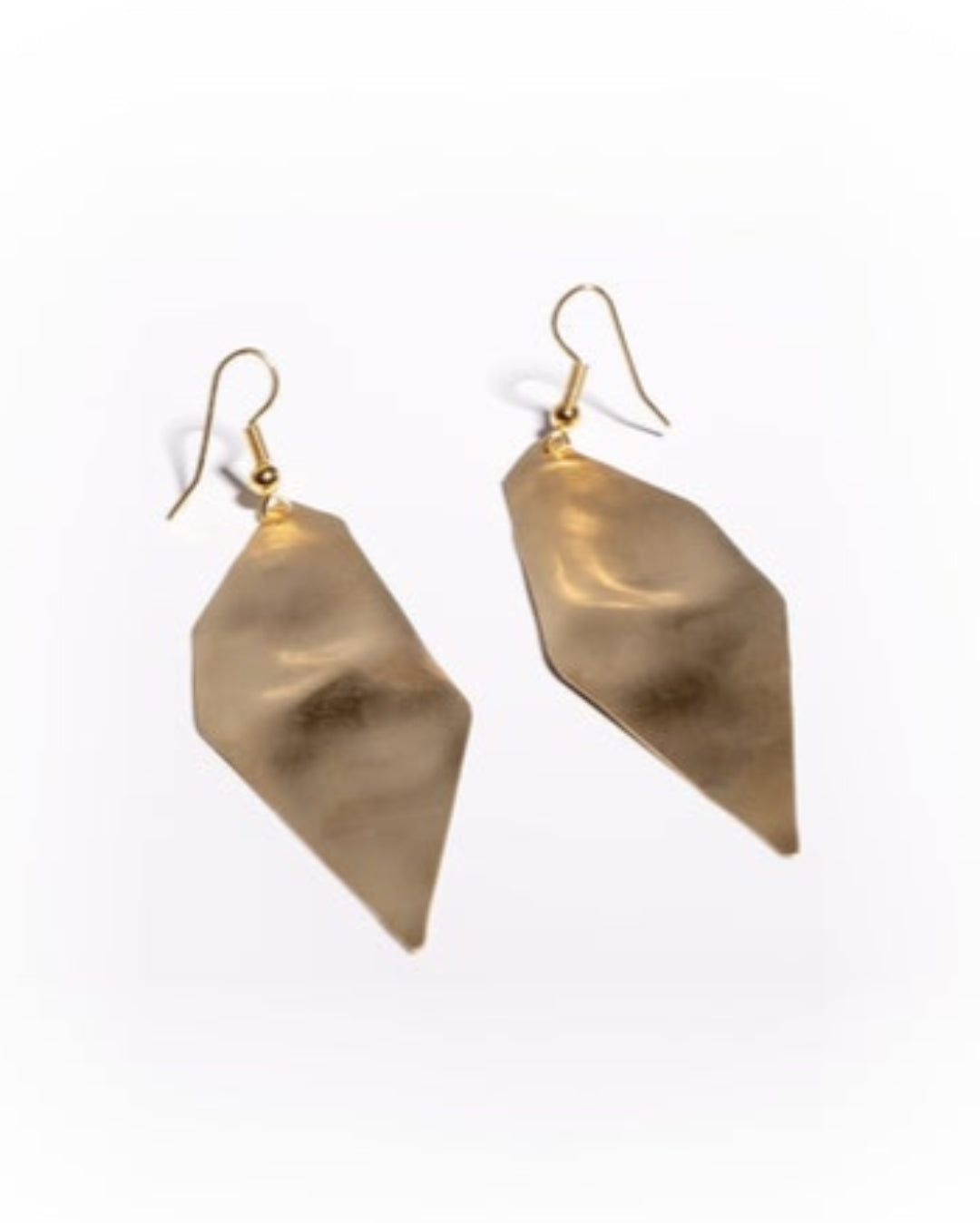 Textured gold earrings on a white background