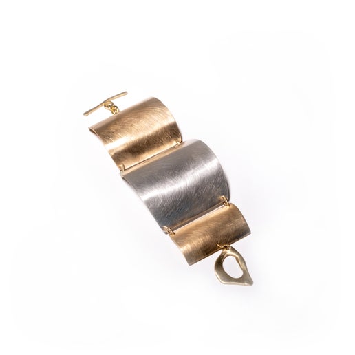Gold and silver bracelet on a white background