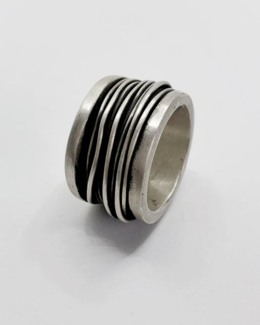 Silver ring with wire detailing on a white background