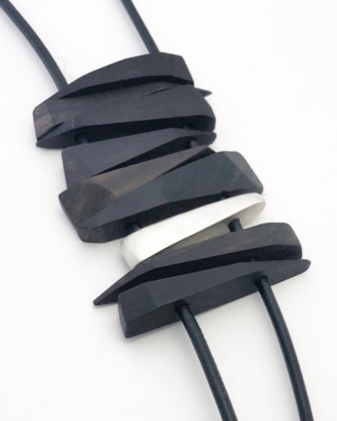 Leather cord necklace with wooden and silver details. 
