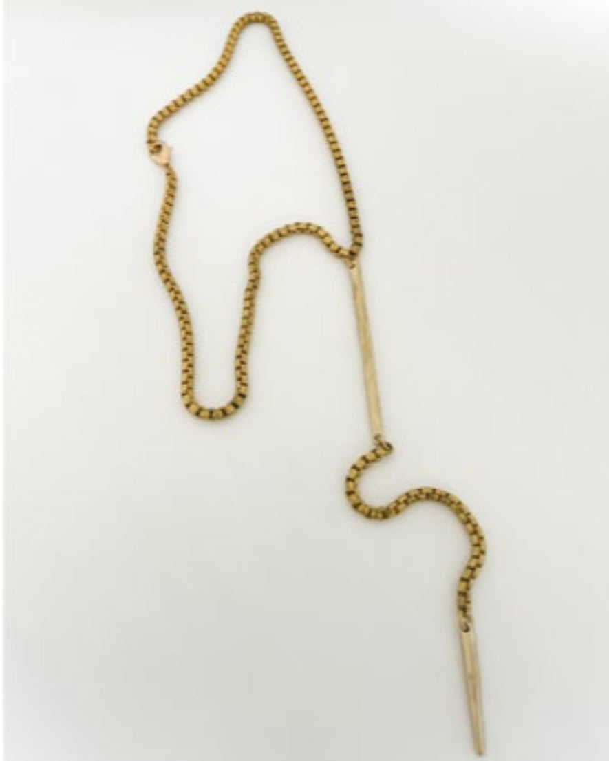 Gold chain necklace with bar detailson a white background